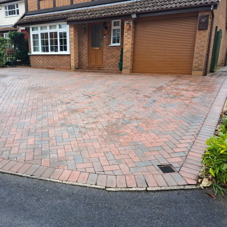 Professional driveway cleaning in the Midlands removing dirt, moss and stains with high-pressure jet washing